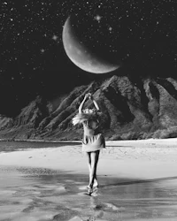 a black and white photo of a girl standing on the beach with the moon in the background